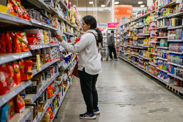 A customer shops for produce at an H-E-B grocery store.
